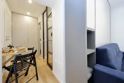 a room with a table and a blue chair at 4BNB - Marmorata Urban Nest in Rome