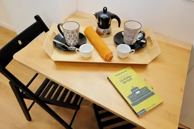 a table with two cups and a tea set on it at 4BNB - Marmorata Urban Nest in Rome