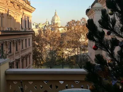 a christmas tree on a balcony with a view of the city at Residenza Cavallini in Rome