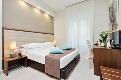 a hotel room with a bed and a television at Relais Servio Tullio in Rome