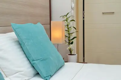 a blue pillow sitting on top of a bed at Relais Servio Tullio in Rome