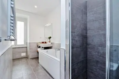 a bathroom with a bath tub and a sink at Relais Servio Tullio in Rome