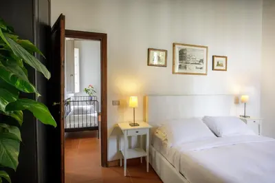 a bedroom with a bed and a table with two lamps at The Right Place 4U Quercia Apartment in Rome