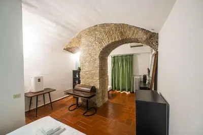 a room with an archway with a desk and a chair at Grotto Apartment by Campo de Fiori in Rome