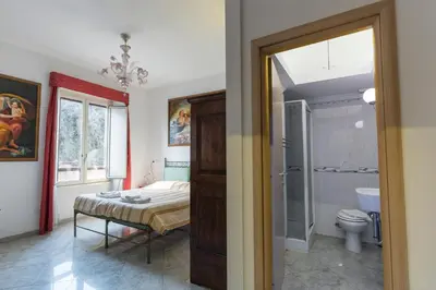 a bathroom with a bed and a toilet in a room at Casavamica in Rome