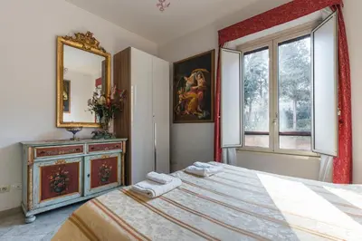 a bedroom with a bed and a mirror and a window at Casavamica in Rome
