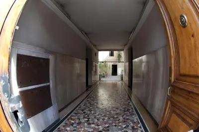 an empty hallway with a door and a tile floor at Casavamica in Rome