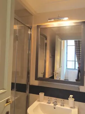a bathroom with a sink and a shower with a mirror at La Casa In Vetrina in Rome