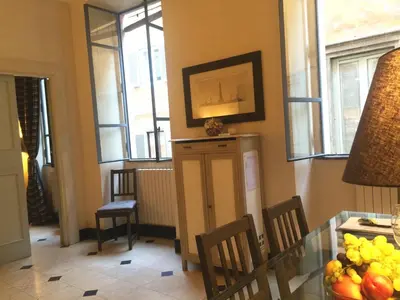 a kitchen with a table and chairs and windows at La Casa In Vetrina in Rome
