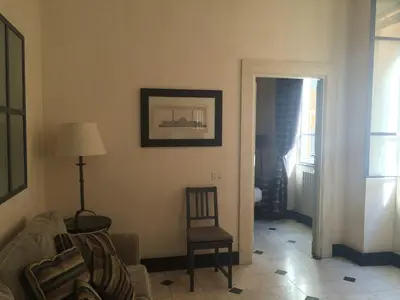 a living room with a chair and a door at La Casa In Vetrina in Rome