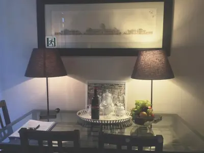 a table with two lamps and a bowl of fruit on it at La Casa In Vetrina in Rome