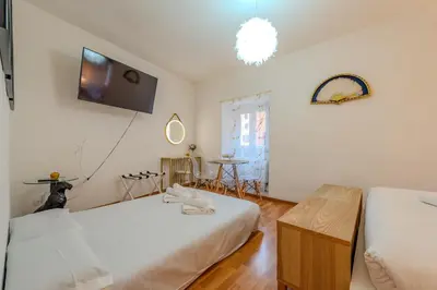 a bedroom with two beds and a tv on the wall at Shalimar House Navona by Ghor in Rome