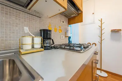 a kitchen counter with a sink and a stove at Shalimar House Navona by Ghor in Rome