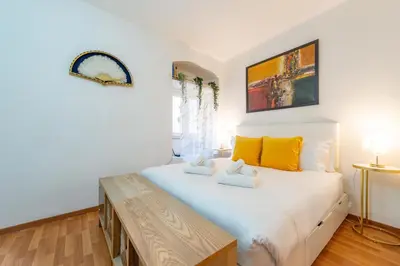 a bedroom with a large white bed with yellow pillows at Shalimar House Navona by Ghor in Rome