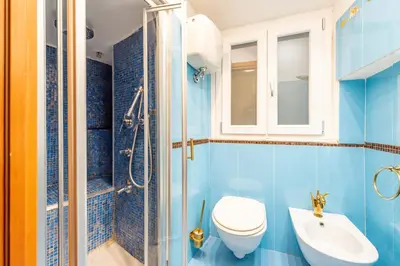 a bathroom with a toilet and a sink and a shower at Shalimar House Navona by Ghor in Rome
