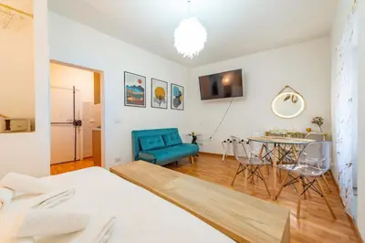 a bedroom with a bed and a table and a blue chair at Shalimar House Navona by Ghor in Rome
