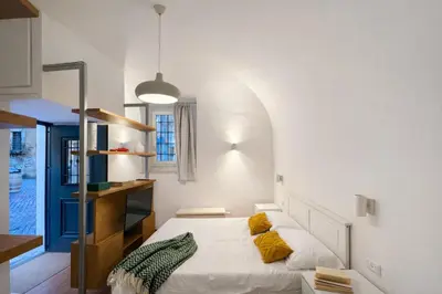 a bedroom with a bed with yellow pillows on it at Studio Coppelle in Rome