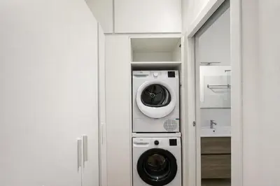 a laundry room with a washer and dryer at Studio Coppelle in Rome