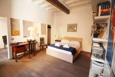 a bedroom with a bed and a desk at The Trevi Fountain and Spanish Steps Experience in Rome