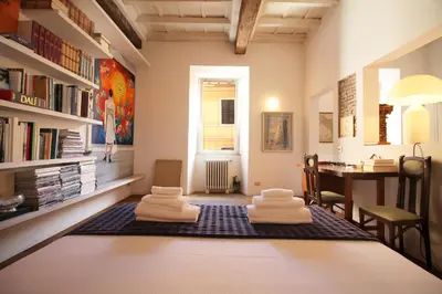 a room with a table with white towels on a rug at The Trevi Fountain and Spanish Steps Experience in Rome