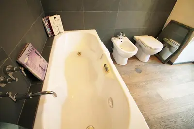 a bathroom with a bath tub and a toilet at The Trevi Fountain and Spanish Steps Experience in Rome