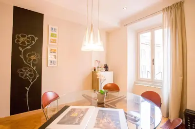 a dining room with a glass table and chairs at Polacchi 42 Apartment in Rome