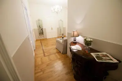 a living room with a table and a mirror at Florian Rooms Guest House in Rome