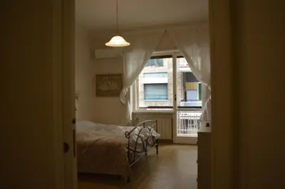 a bedroom with a bed and a large window at Home Sweet Home in Rome