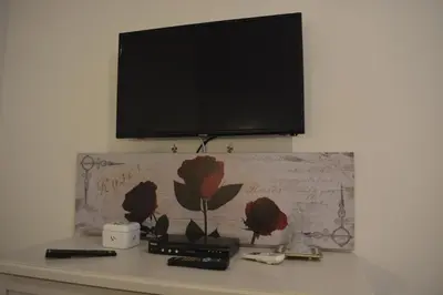a flat screen tv on top of a desk at Home Sweet Home in Rome