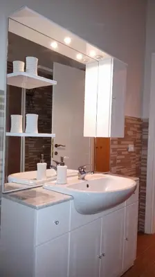 a bathroom with a white sink and a mirror at Home Sweet Home in Rome