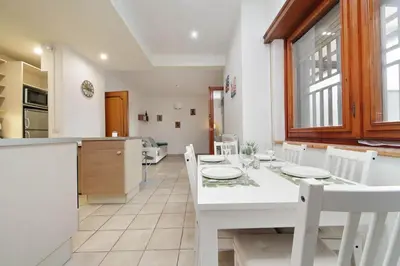 a kitchen and dining room with a white table and chairs at 4BNB - Viale Vaticano terrace retreat in Rome