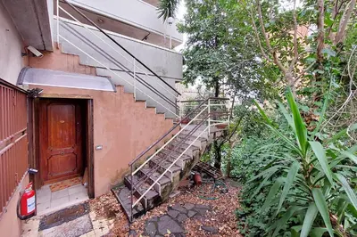 a metal staircase next to a building with a door at 4BNB - Viale Vaticano terrace retreat in Rome