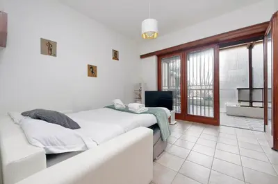 a bedroom with a bed and a couch and a television at 4BNB - Viale Vaticano terrace retreat in Rome