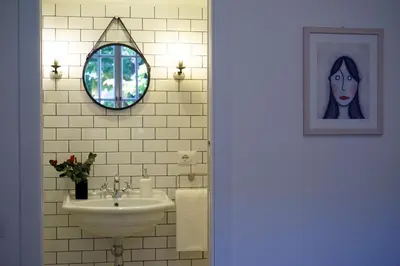 a bathroom with a sink and a picture of a woman at Guest House Interno4 in Rome