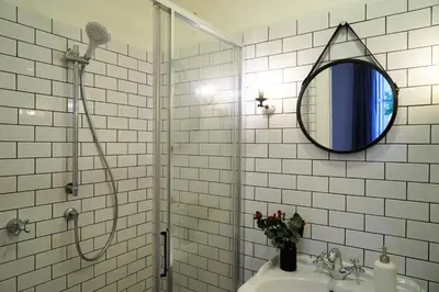 a bathroom with a shower with a mirror and a sink at Guest House Interno4 in Rome