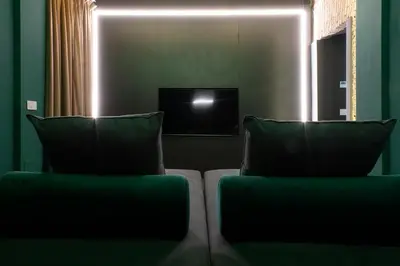 a couch with two pillows in a living room at Colonna Suite Del Corso in Rome