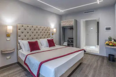 a large bedroom with a large bed with red pillows at Colonna Suite Del Corso in Rome