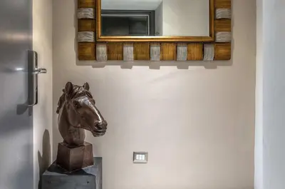 a statue of a horse in a room with a mirror at Colonna Suite Del Corso in Rome