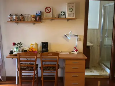 a room with a desk with two chairs and a lamp at B&B La Terrazza in Rome