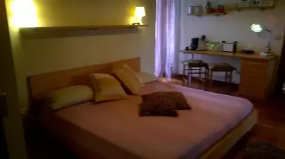 a bedroom with a large bed with yellow pillows at B&B La Terrazza in Rome