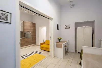 a living room with a yellow couch and a table at A 20 Gradini dai Musei Vaticani in Rome