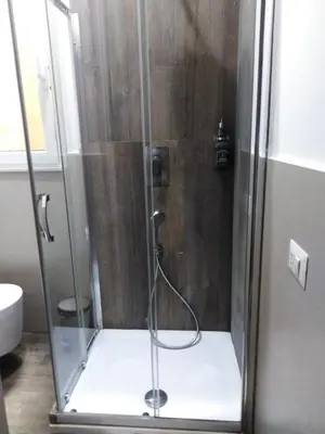 a shower with a glass enclosure in a bathroom at YourStay@Rome Coliseum in Rome
