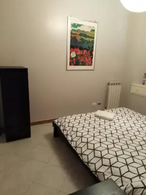 a bedroom with a bed and a painting on the wall at YourStay@Rome Coliseum in Rome