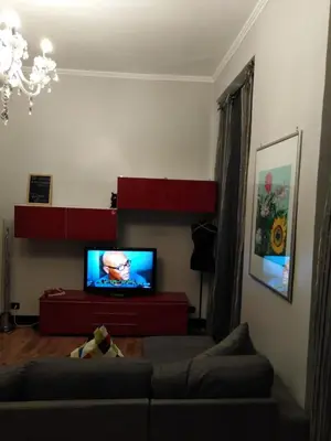 a living room with a couch and a flat screen tv at YourStay@Rome Coliseum in Rome