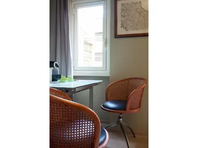 a room with two chairs and a table and a window at Alex's Guest House in Rome