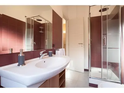 a bathroom with a white sink and a shower at Alex's Guest House in Rome