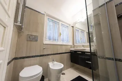 a bathroom with a toilet and a sink at Margutta's Garden in Rome