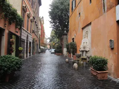 a cobblestone street in an old town with plants at Margutta's Garden in Rome