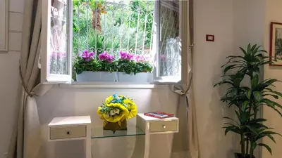 a room with a window with flowers on it at Margutta's Garden in Rome
