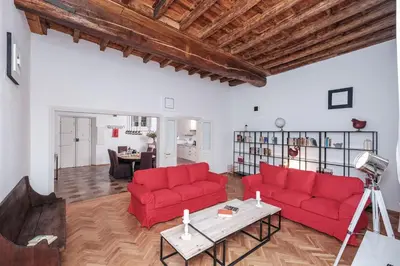 a living room with two red couches and a table at Trastevere Wonderful 3BR Apartment in Rome